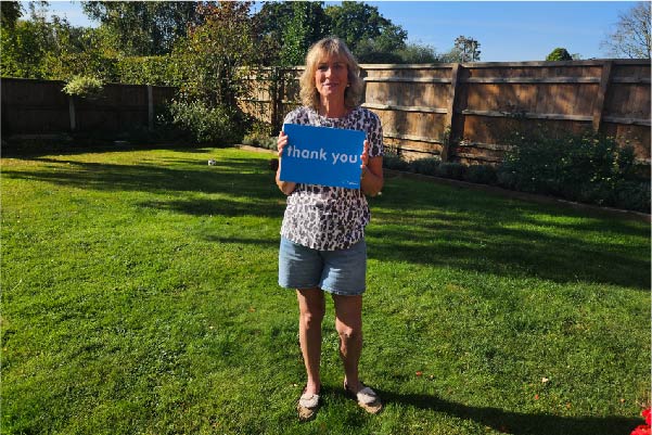 Stella holding a thank you sign