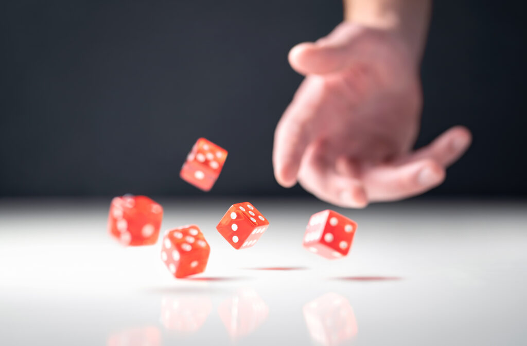 Hands throwing dice to gamble