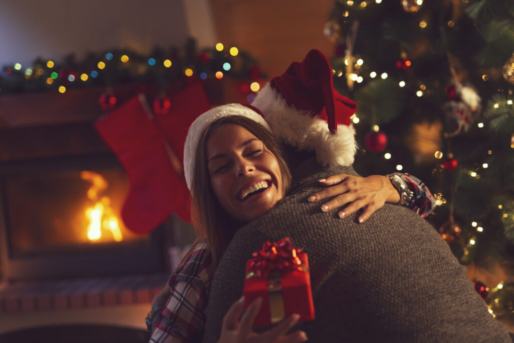 Young woman receiving a Christmas gift.