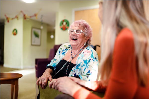 Old lady with breathing tubes laughing