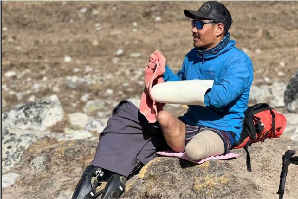 Hari sat down adjusting his prosthetic limbs